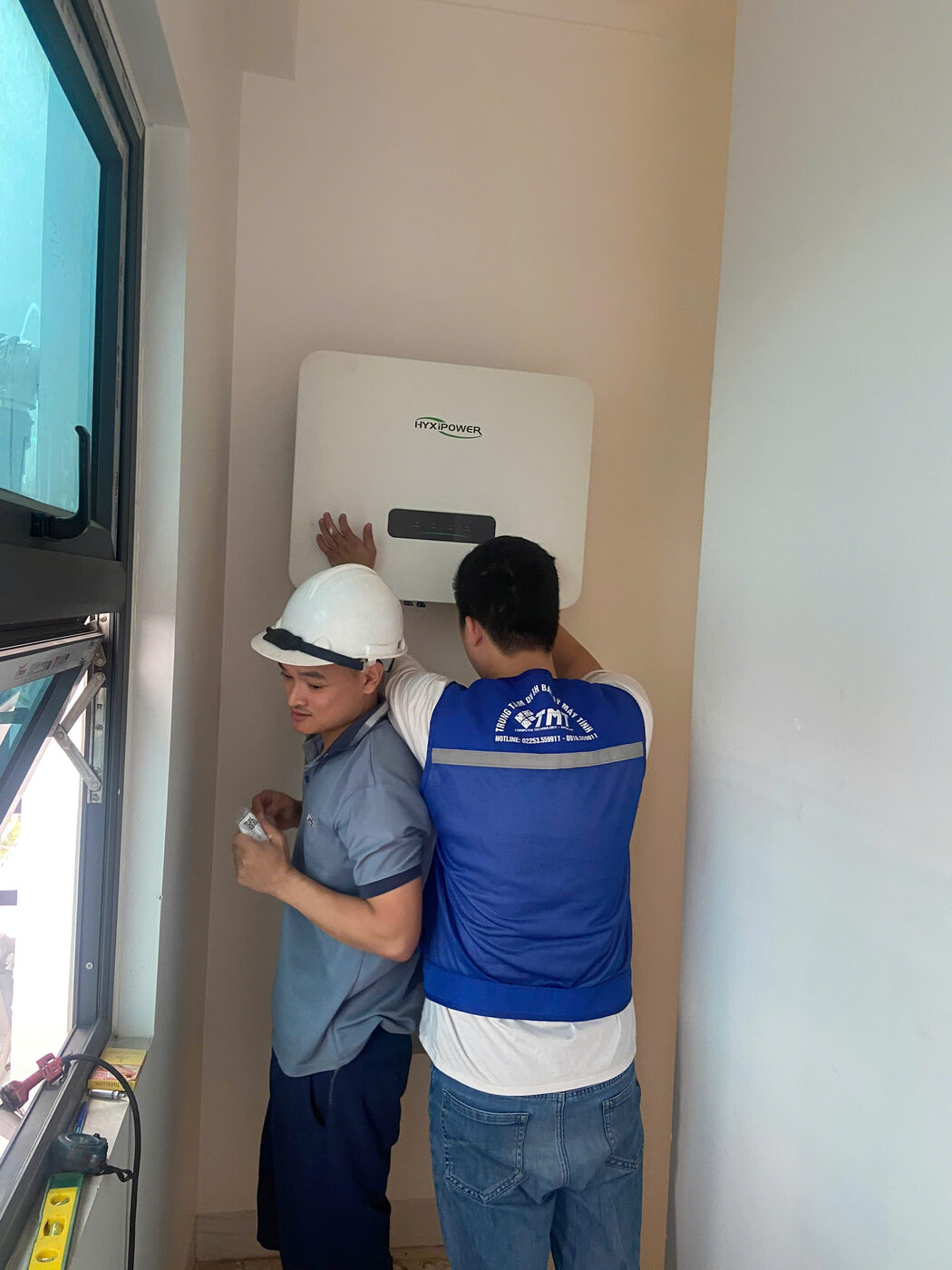 Hai kỹ thuật viên TMT cùng kiểm tra biến tần sau lắp đặt