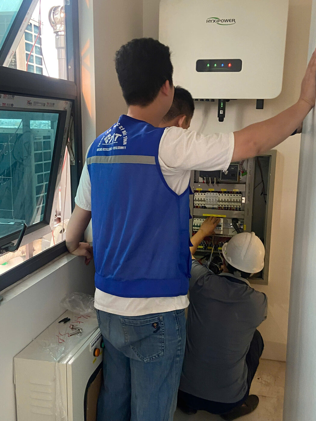 Kỹ thuật viên TMT áo xanh lắp biến tần lên tường tại công trình Hải Phòng